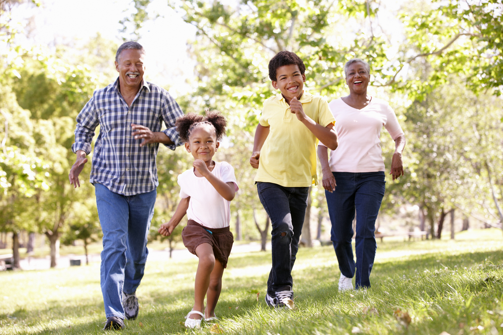 Två barn och två vuxna som springer
