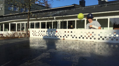 En tennisboll som flyger över nätet på ett pingisbord.
