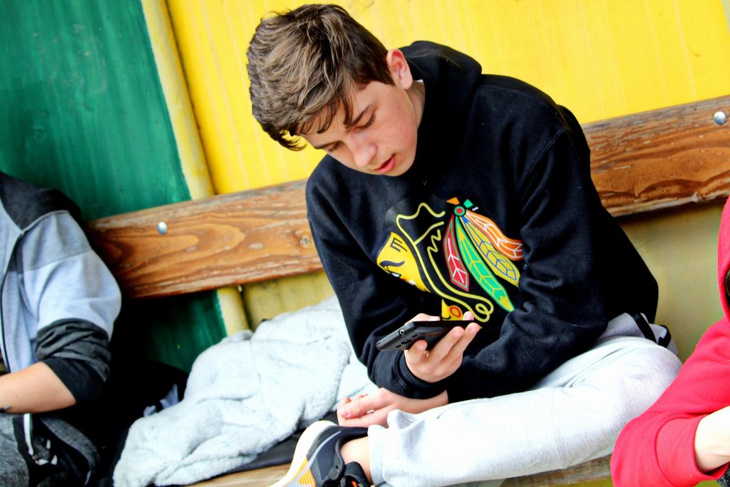 En kille som läser i sin mobil